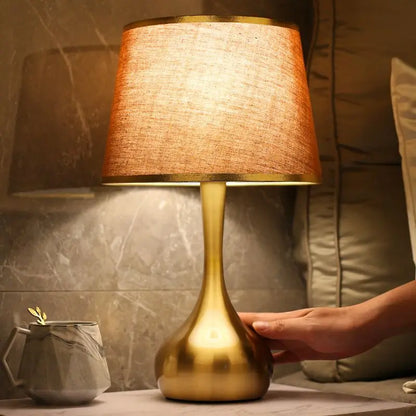 Sophisticated table lamp Luminis with gold metal base and fabric shade in cosy ambiance – view 4