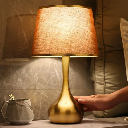 Sophisticated table lamp Luminis with gold metal base and fabric shade in cosy ambiance – view 6